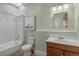 Clean bathroom with a shower-tub combination, and wooden vanity at 914 E Iowa Ave, Denver, CO 80210