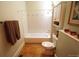 This simple bathroom features a tub, a toilet and a white wall cabinet for storage at 914 E Iowa Ave, Denver, CO 80210