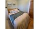 Comfortable bedroom showcasing a wooden door and calm decor at 914 E Iowa Ave, Denver, CO 80210