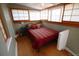 Compact bedroom features wood floors, shoji-style windows and a comfortable bed at 914 E Iowa Ave, Denver, CO 80210