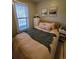 Inviting bedroom with neutral tones, soft bedding, and a cozy ambiance at 914 E Iowa Ave, Denver, CO 80210