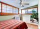 Cozy bedroom with shoji-style windows, ceiling fan, and bench seating at 914 E Iowa Ave, Denver, CO 80210
