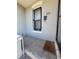 A welcoming entrance of a home with concrete porch and protective bars on the window at 914 E Iowa Ave, Denver, CO 80210