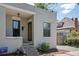 Exterior view of a gray painted brick house with steps leading to the front door at 914 E Iowa Ave, Denver, CO 80210