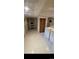 Bright laundry room featuring a washer, dryer, shelving, tile flooring, and a closet for storage solutions at 914 E Iowa Ave, Denver, CO 80210