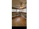Bright living room featuring hardwood floors, shelving, and a ceiling fan at 914 E Iowa Ave, Denver, CO 80210