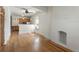 Bright and open living room featuring hardwood floors, a decorative fireplace, and an adjoining kitchen at 914 E Iowa Ave, Denver, CO 80210