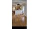 Open-concept living area with hardwood floors, bright windows, and a view of the kitchen at 914 E Iowa Ave, Denver, CO 80210