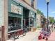 Exterior view of Greentree Cyclery featuring bicycles on display, vintage signage, and a brick facade at 914 E Iowa Ave, Denver, CO 80210