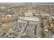Extended aerial view shows the townhome community and nearby city skyline in the distance at 1007 Chase St, Lakewood, CO 80214