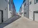 Back alley of modern townhomes with garages and consistent architectural design at 1007 Chase St, Lakewood, CO 80214