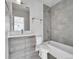 Bathroom featuring light gray tiling, contemporary vanity, and built-in shower and tub at 1007 Chase St, Lakewood, CO 80214
