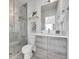 Contemporary bathroom featuring a glass-enclosed shower, modern vanity, and neutral color scheme at 1007 Chase St, Lakewood, CO 80214