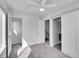 Neutral bedroom featuring carpet, closet, ceiling fan and access to adjacent bathroom at 1007 Chase St, Lakewood, CO 80214