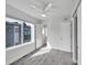 Bedroom with gray carpet, closet, ceiling fan and bright window views to the outside at 1007 Chase St, Lakewood, CO 80214