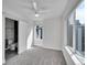 Bright bedroom with large windows, carpet, and ceiling fan, with bathroom and closet at 1007 Chase St, Lakewood, CO 80214