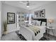 Bright bedroom with large windows, plush bedding, stylish decor, and modern ceiling fan at 1007 Chase St, Lakewood, CO 80214