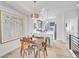 Bright dining area featuring a wooden table set, modern lighting, and stylish artwork at 1007 Chase St, Lakewood, CO 80214