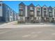 Street view of new townhomes with modern exteriors, showcasing a contemporary design at 1007 Chase St, Lakewood, CO 80214