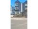Modern three-story townhome with a black metal balcony and a small fenced-in yard at 1007 Chase St, Lakewood, CO 80214