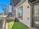 Close up of front yard with artificial turf, black planters, and the home's address at 1007 Chase St, Lakewood, CO 80214