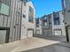 View of townhouse exteriors with private garages and coordinated gray and white design at 1007 Chase St, Lakewood, CO 80214