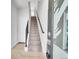 Entryway with stairs featuring metal railings, carpeted treads, and modern accents at 1007 Chase St, Lakewood, CO 80214