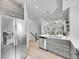 Open kitchen featuring stainless steel appliances and a view of the staircase at 1007 Chase St, Lakewood, CO 80214