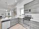 Modern kitchen features sleek gray cabinetry, stainless steel appliances, and ample counter space at 1007 Chase St, Lakewood, CO 80214