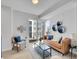 Cozy living room with a leather sofa, decorative pillows, and a glass coffee table at 1007 Chase St, Lakewood, CO 80214