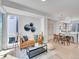 Open-concept living space with modern furnishings and a seamless flow into the kitchen and dining area at 1007 Chase St, Lakewood, CO 80214