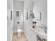 Well-lit powder room with modern fixtures, elegant mirror, and a clean, minimalist design at 1007 Chase St, Lakewood, CO 80214