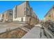 Exterior view of townhomes featuring modern design, landscaping, and ample parking at 1007 Chase St, Lakewood, CO 80214