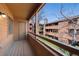 Private balcony with railing and wooden deck, offering a serene outdoor space with community views and storage at 4681 S Decatur St # 227, Englewood, CO 80110