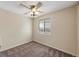 This bedroom features neutral walls, carpet, and a window providing natural light and a ceiling fan at 4681 S Decatur St # 227, Englewood, CO 80110