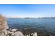 Scenic lake view with clear blue water, rock-lined shore, and a beautiful, serene landscape on a sunny day at 4681 S Decatur St # 227, Englewood, CO 80110