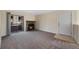 Bright living room featuring a stone fireplace, sliding glass door to balcony, neutral carpeting, and a welcoming atmosphere at 4681 S Decatur St # 227, Englewood, CO 80110