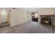 Comfortable living room featuring a stone fireplace, sliding glass door to balcony, neutral carpeting, and modern lighting at 4681 S Decatur St # 227, Englewood, CO 80110