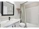 A well lit bathroom features a large mirror and shower and bath combination at 6142 Gorham St, Frederick, CO 80530