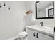 Modern bathroom featuring a sleek vanity, a well-lit mirror, and minimalist decor for a clean, contemporary feel at 6142 Gorham St, Frederick, CO 80530