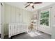 Charming Bedroom featuring a modern crib, stylish decor, and natural light, creating a cozy and inviting space at 6142 Gorham St, Frederick, CO 80530