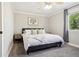 Comfortable bedroom showcasing soft neutral tones, plush carpet, and bright natural light from the window at 6142 Gorham St, Frederick, CO 80530