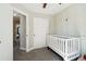 This adorable Bedroom features light walls and a modern, white crib at 6142 Gorham St, Frederick, CO 80530
