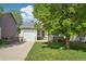 Beautifully landscaped front yard with healthy green lawn and mature shade tree enhance this charming home's curb appeal at 6142 Gorham St, Frederick, CO 80530