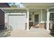 Inviting front porch features stone accents and decorative pillars, leading to the front door and attached garage at 6142 Gorham St, Frederick, CO 80530