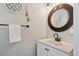 Stylish half bathroom featuring a modern vanity, sleek mirror, and elegant decor at 6142 Gorham St, Frederick, CO 80530