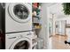 Efficient laundry area featuring stacked washer and dryer, plus pantry shelving for convenient storage at 6142 Gorham St, Frederick, CO 80530