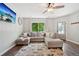 Comfortable living room featuring a stylish sectional, decorative rug, and a large window for natural light at 6142 Gorham St, Frederick, CO 80530