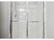 Modern shower features sliding glass doors and pristine white tile at 6142 Gorham St, Frederick, CO 80530