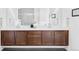 Bathroom featuring a double vanity with dark wood cabinets, white countertops, and modern fixtures at 6251 N Galena St, Denver, CO 80238